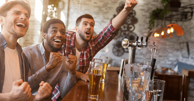 Group of men drinking beer at a bar