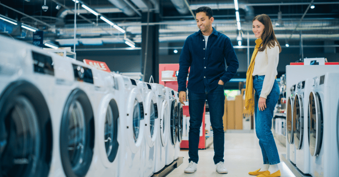 Couple shopping for washing machines, consumer electronics, and home appliances.