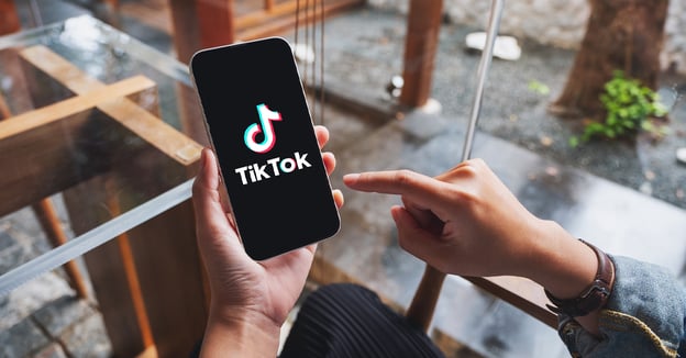 Phone with TikTok open and TikTok Shoppable Videos